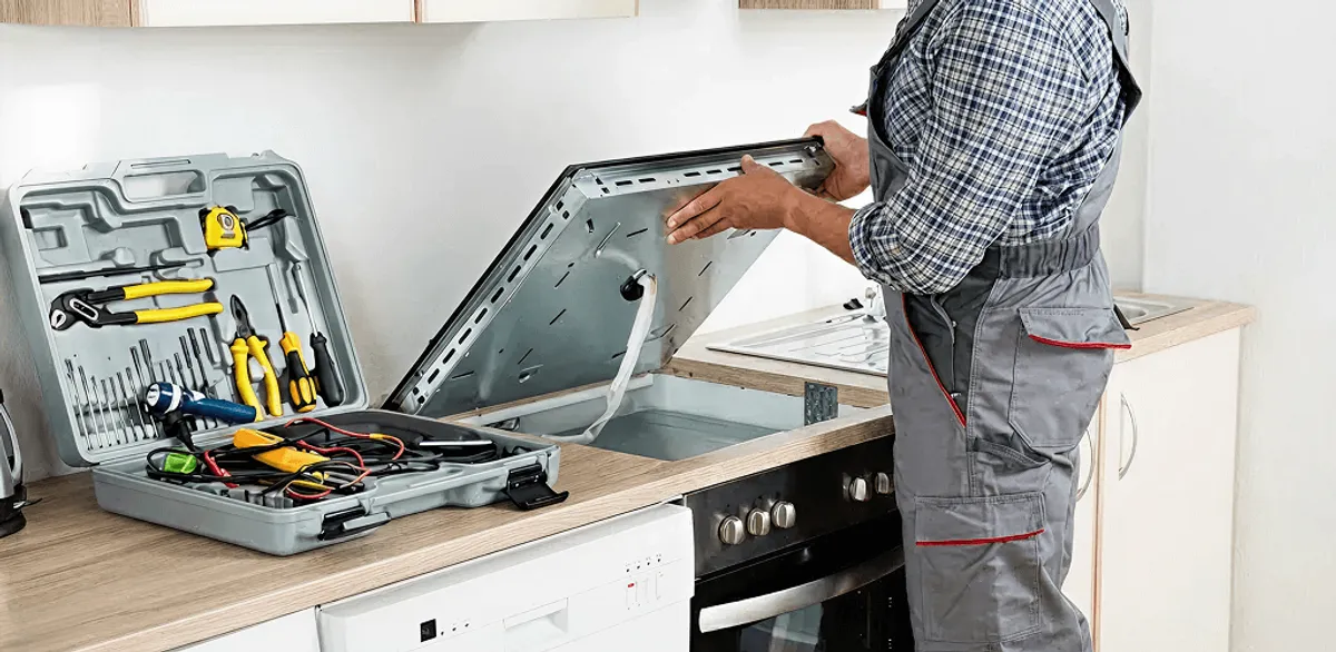 Handyman repairing a cooktop and checking wiring connections in Boise, ID